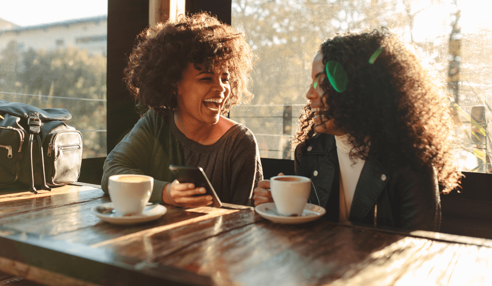 Two women conversing over coffee in a cafe.